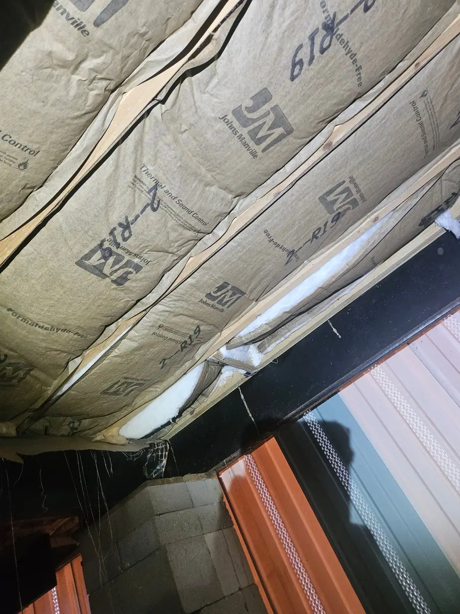 New insulation batts fitted along the steel beam under a manufactured home