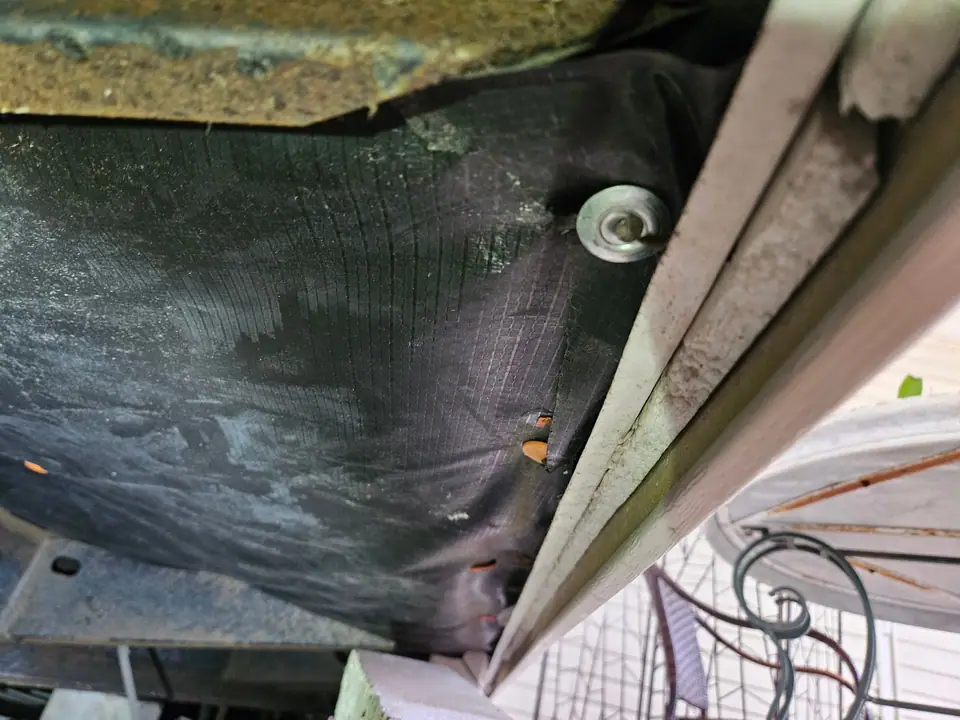 New belly wrap fastened under a manufactured home, seen at the frame