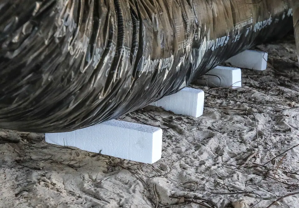 New insulated flex duct set on blocks under a manufactured home