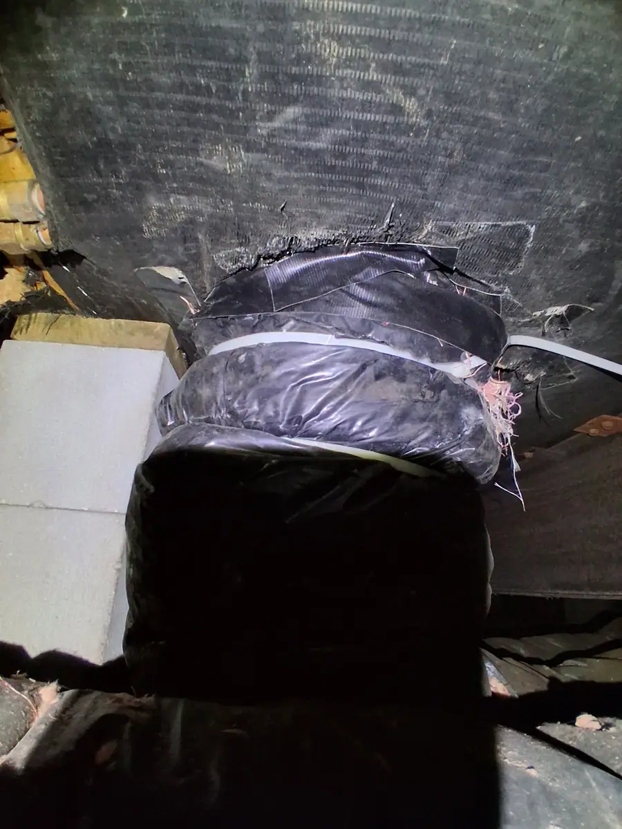 Flex duct connection wrapped and sealed under a manufactured home