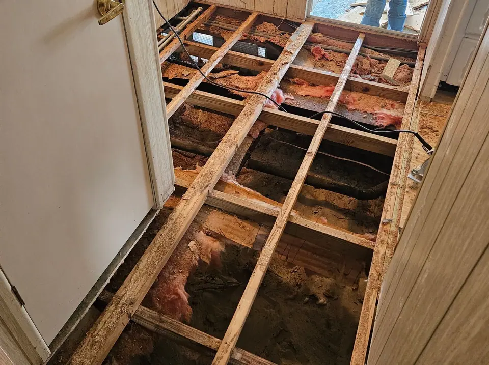 Hallway floor opened to the joists for a soft floor repair in Spring Hill, FL