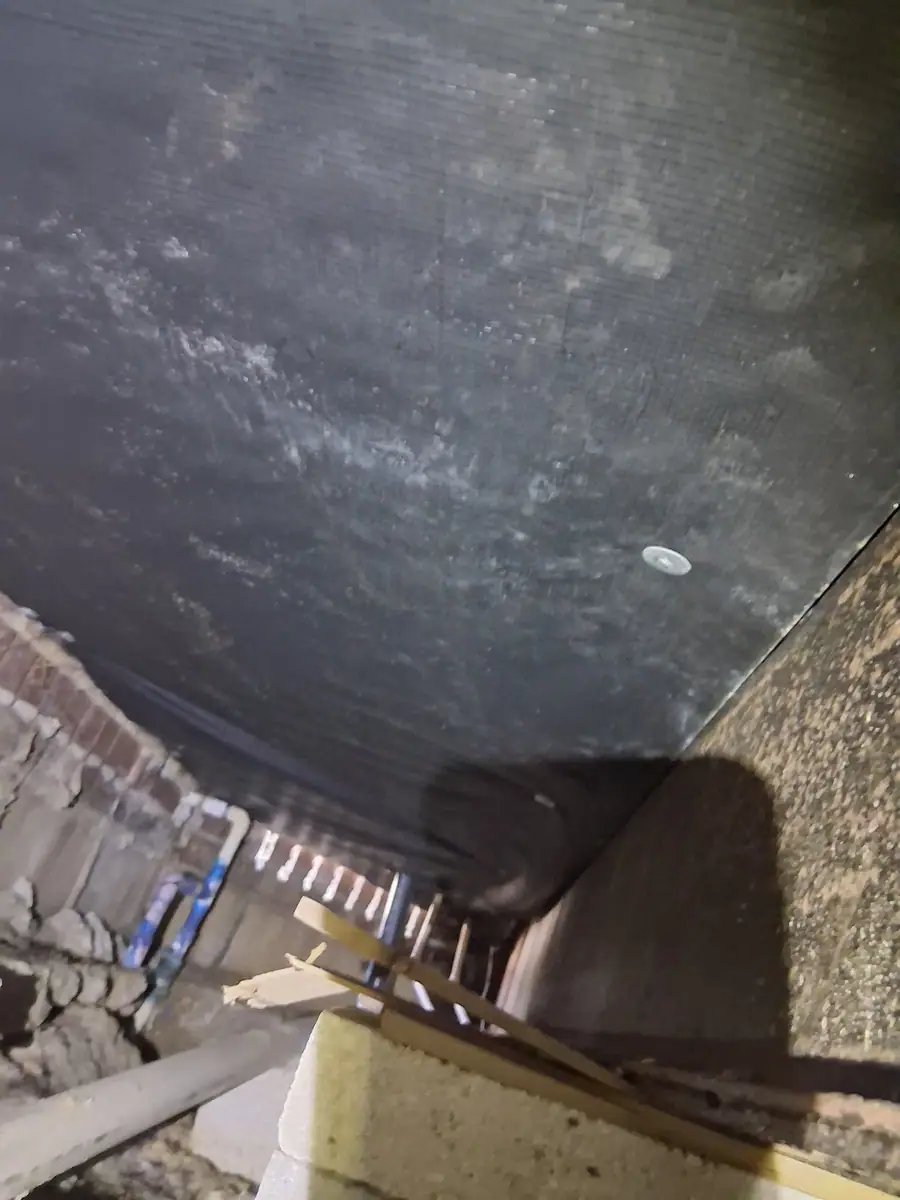 Black belly wrap with a round fastener above the crawl space
