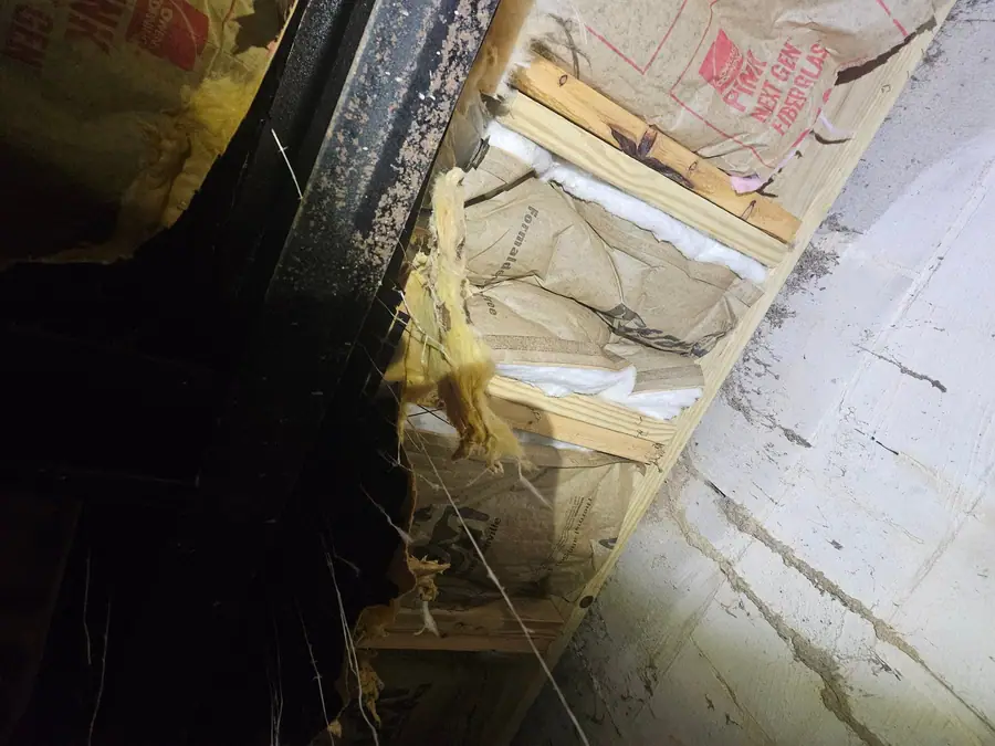 Insulation batts fitted between the joists beside the steel beam