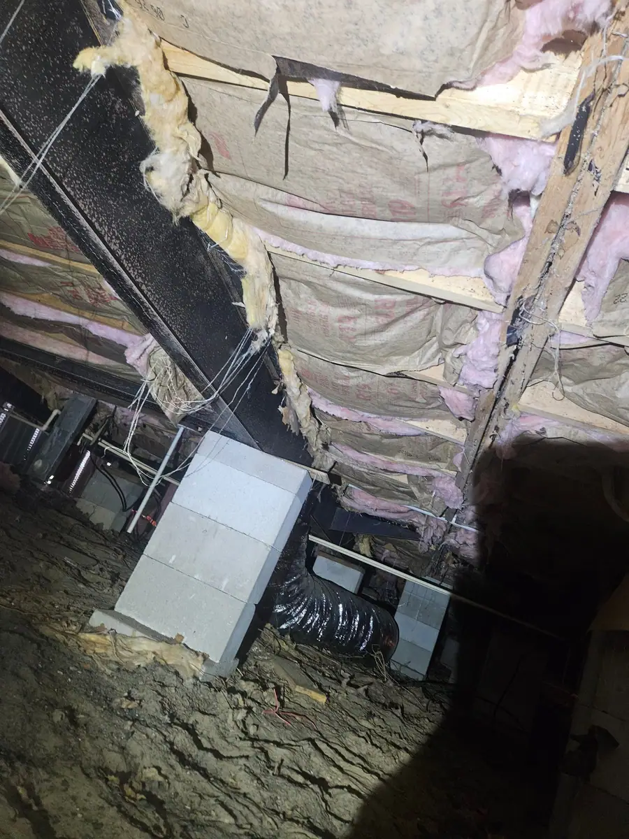 Rows of insulation batts above block piers and ducts