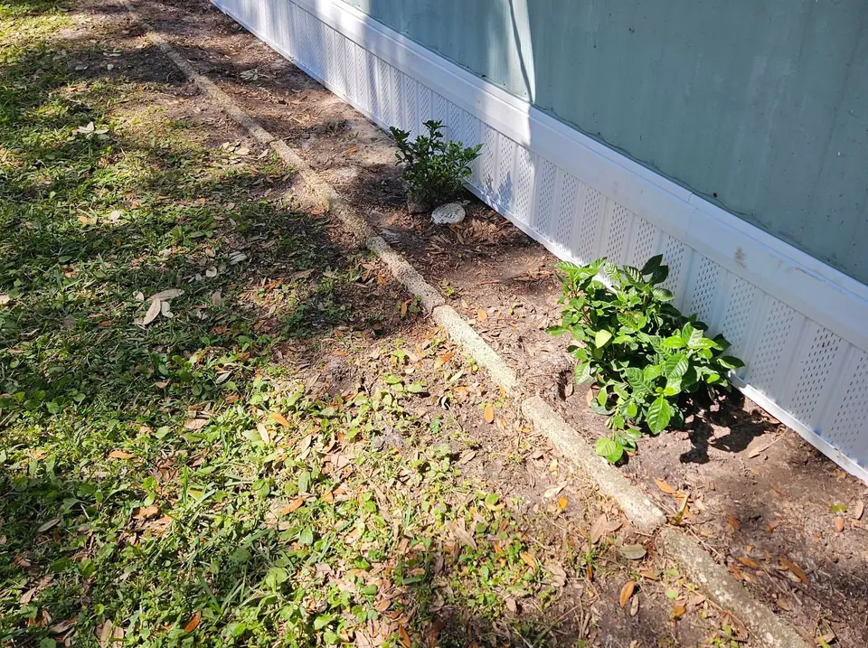 A blue manufactured home with finished white skirting in Spring Hill, FL