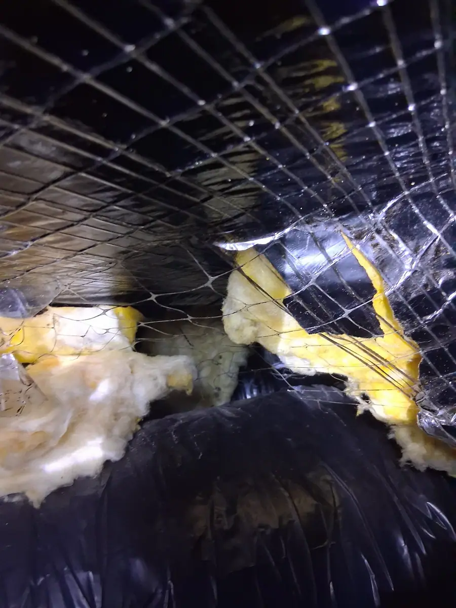 Wire mesh holding new insulation up under the floor before the belly wrap goes on