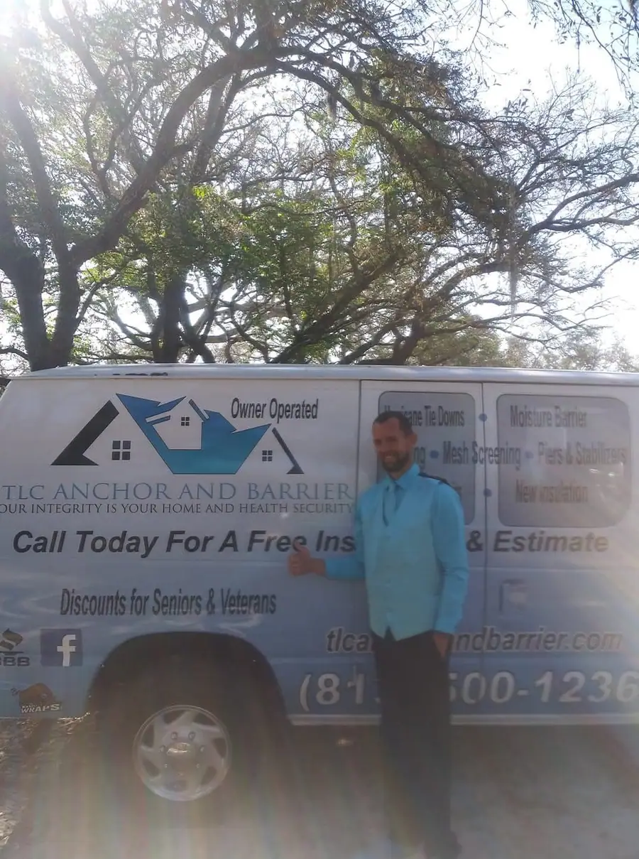 The TLC Anchor and Barrier work van, lettered with the logo and services, parked under a live oak