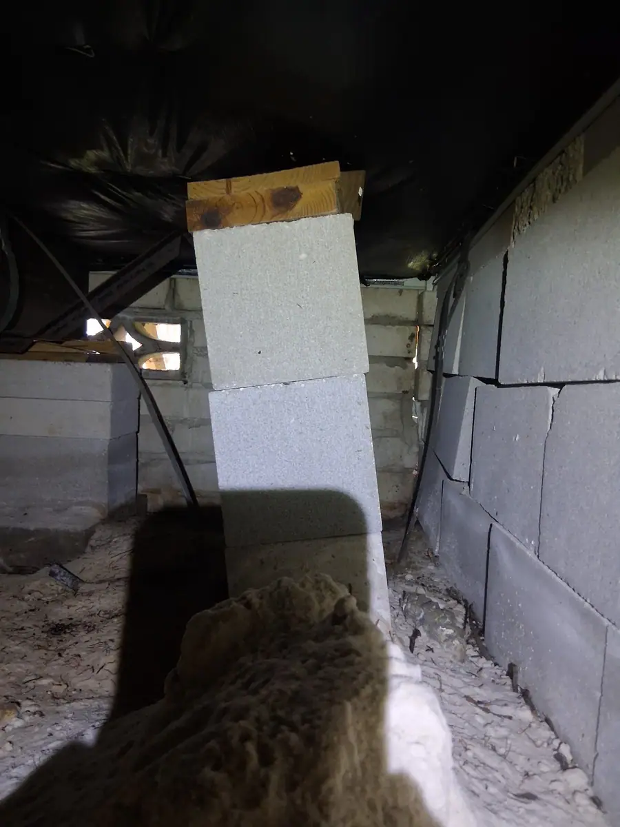 Block pier with cap and shims set under the frame